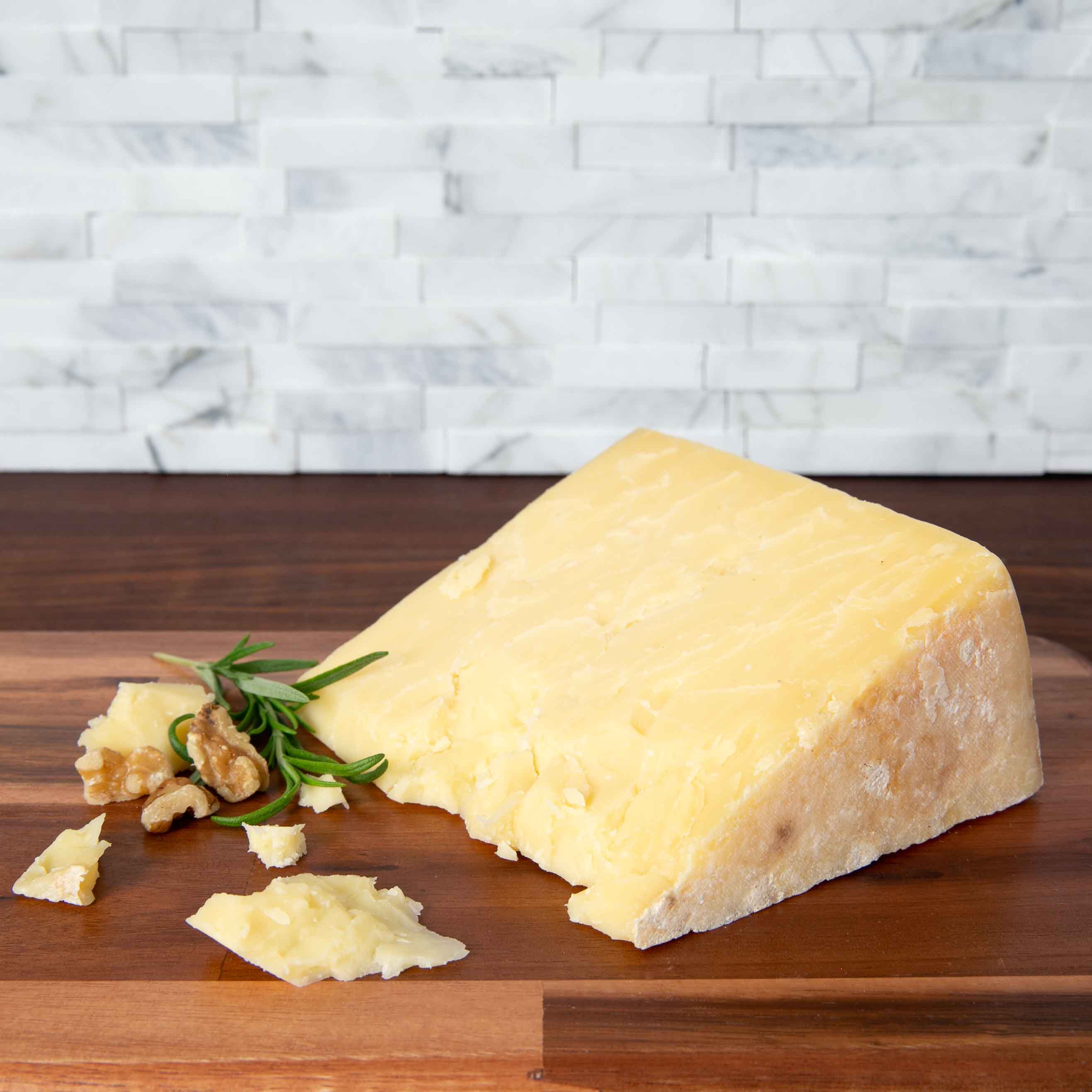 Keens Bandaged Cheddar Cheese wedge on wooden board