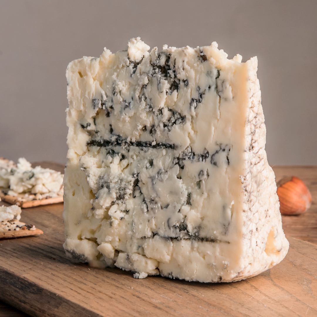 Smokey Blue Cheese wedge on cutting board