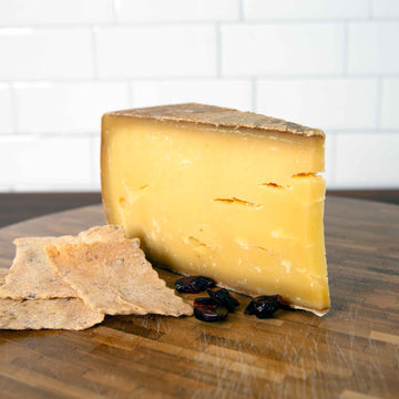 Alpkäse 2021 cheese on wooden board