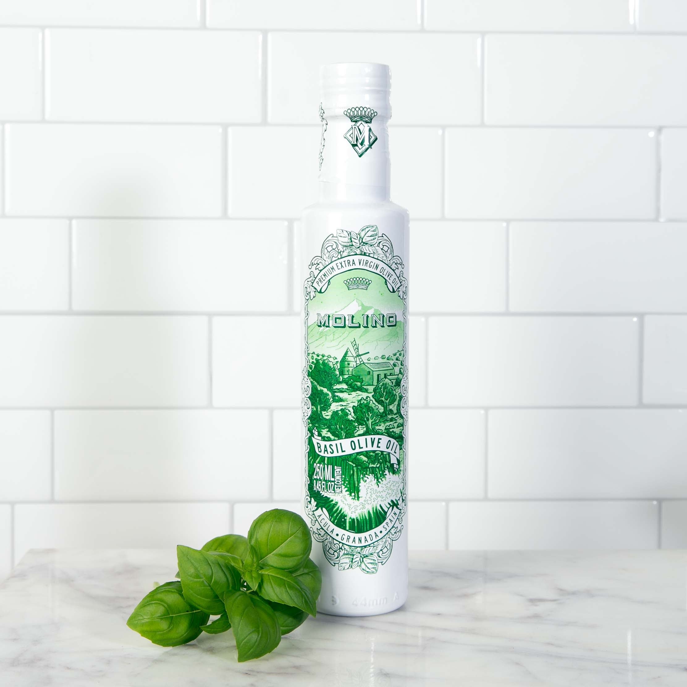 Bottle of Molino Basil Olive Oil on marble countertop