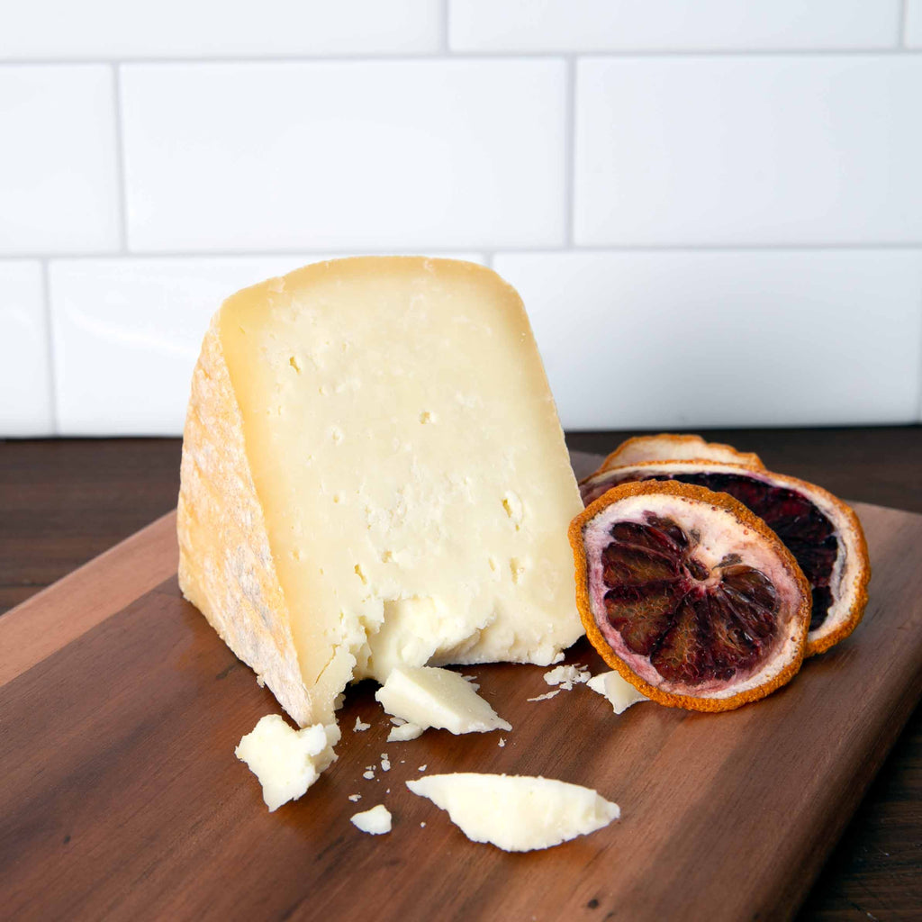 Pecorino Maremmano cheese on wooden board