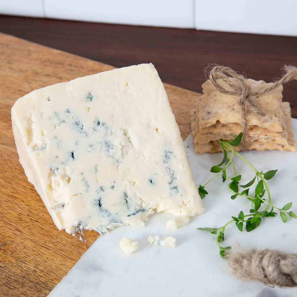 Smokey Blue Cheese on cutting board with crackers